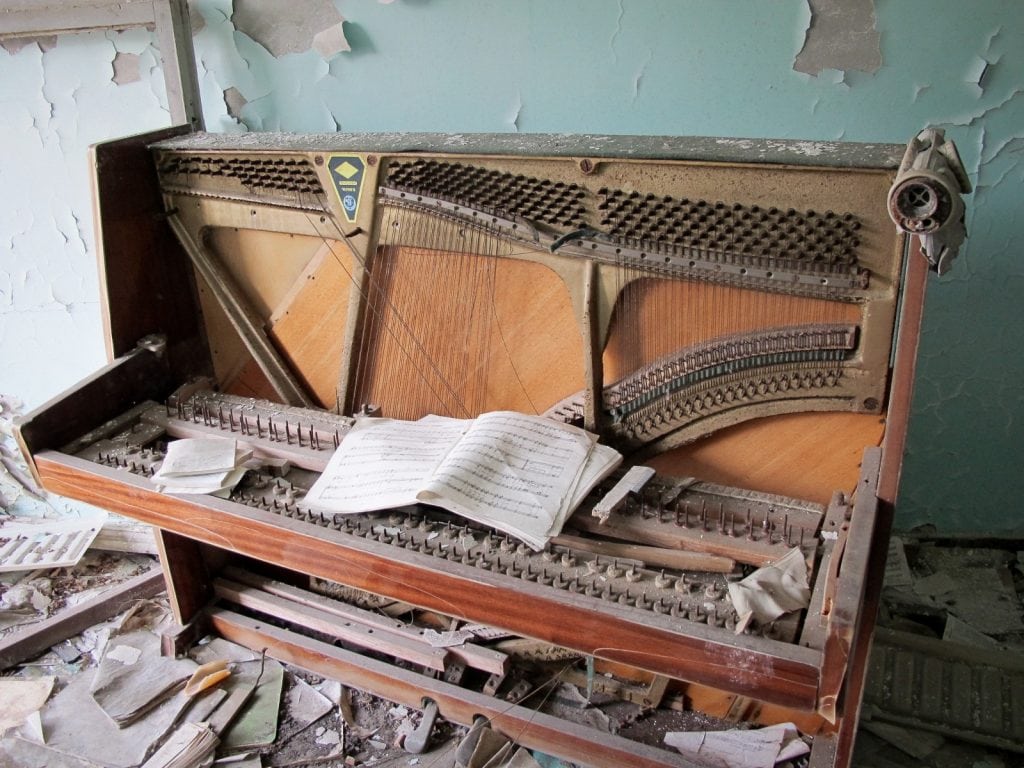 Visiting the Chernobyl Exclusion Zone; piano in Pripyat, Ukraine