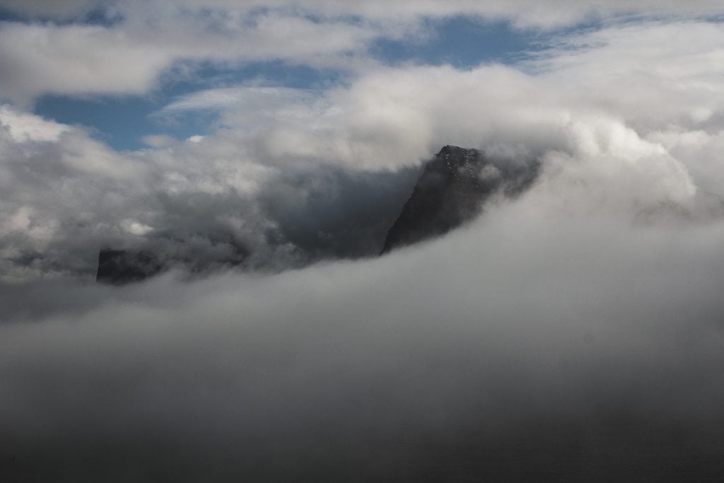 hiking through fog in the faroe islands in trøllanes to the kallur lighthouse on kalsoy island