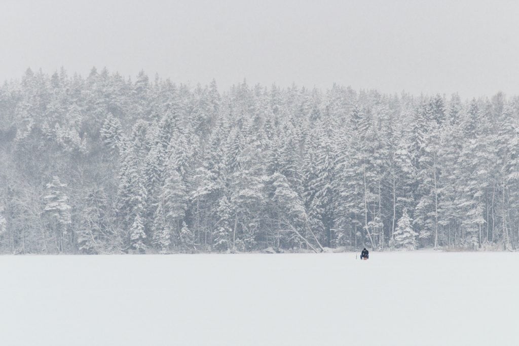 Nuuksio National Park: The Most Beautiful Winter Day Trip From Helsinki ice fishing on frozen lake