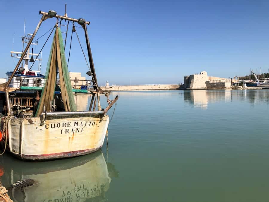 Lonely boat by the Trani harbor in Italy Puglia region