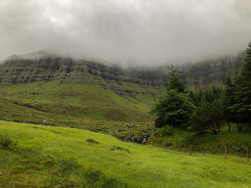 An island in the north of the Faroe Islands that often is forgotten about is Kunoy island. This is a Kunoy travel guide, including the forest on Kunoy and more.