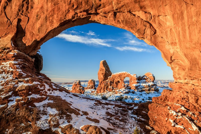 Sunrise of North Window Arch and Turret Arch after snow in Arches National Park in winter