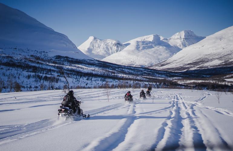 Snowmobiling through Tromso's wilderness