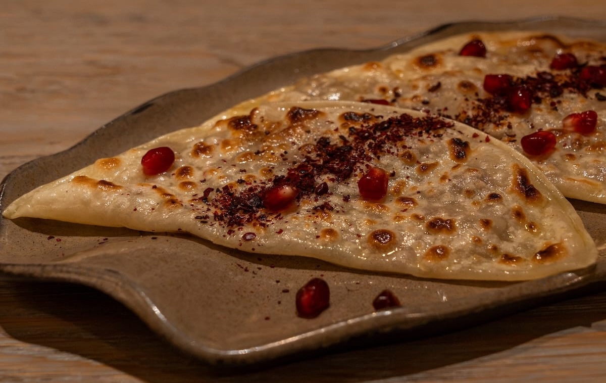 a dish of fried flatbreads covered in sumac and pomegranate seeds
best restaurants in almaty, kazakhstan