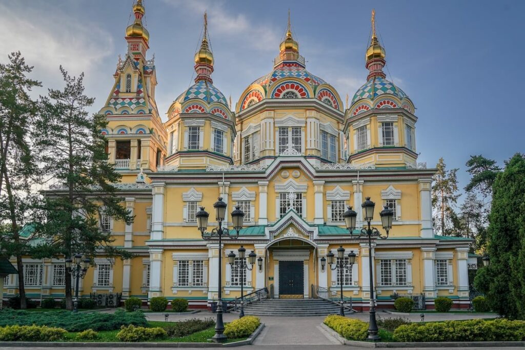 One day in Almaty itinerary a wooden yellow church with a blue sky