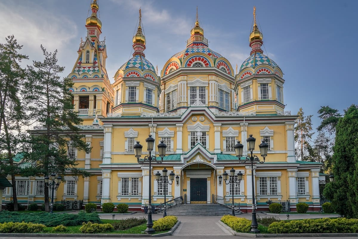 One day in Almaty itinerary a wooden yellow church with a blue sky