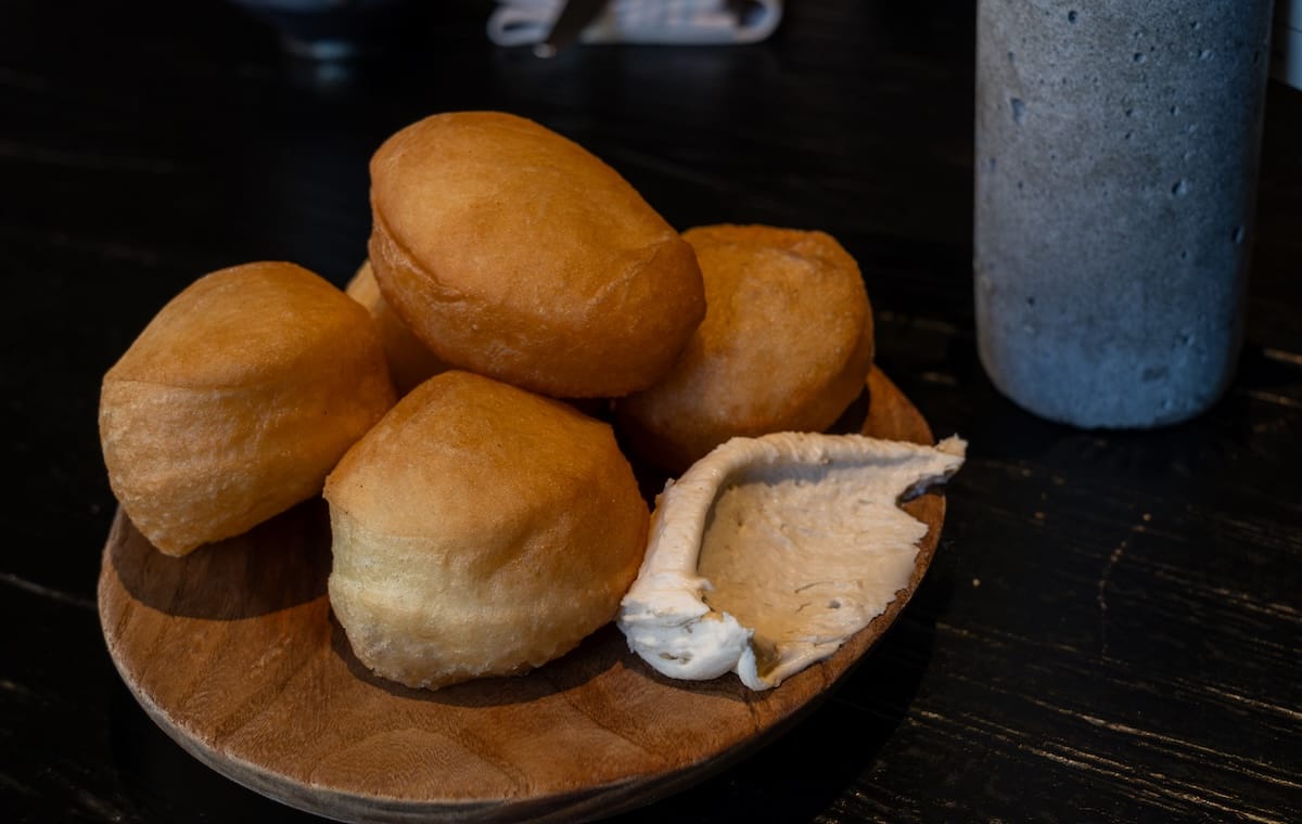 fried doughnuts on a plate with a cream called qaimaq in kazakhstan
best restaurants in almaty, kazakhstan