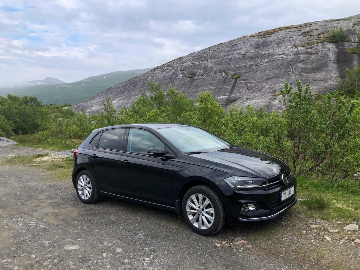 A black car overlooking a beautiful mountain area in Bodø Norway