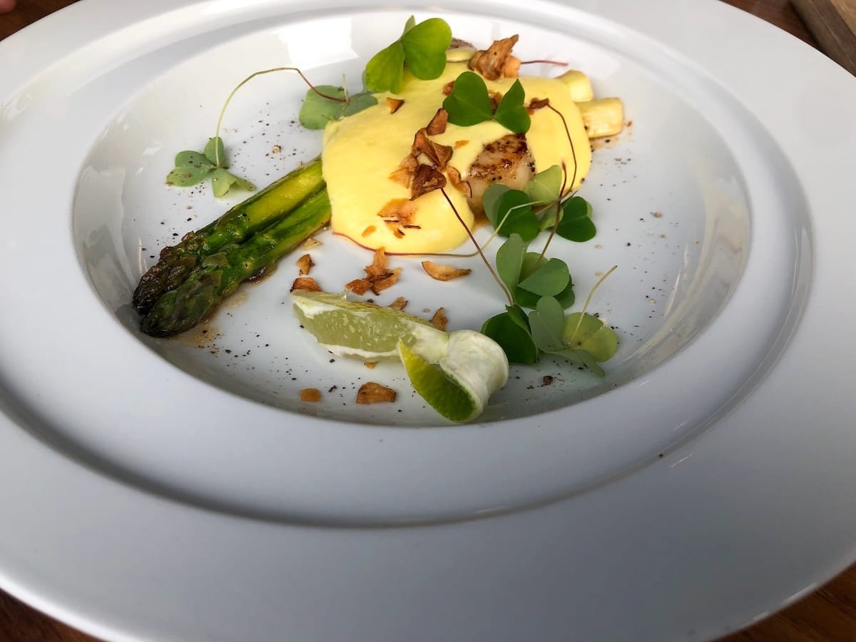 A plate with asparagus and bacon and hollandaise sauce from a Norwegian restaurant
