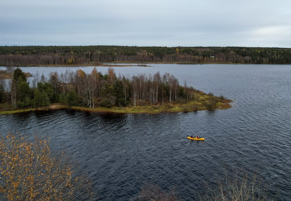 two people in a canoe from a drone shot in a lake in lapland