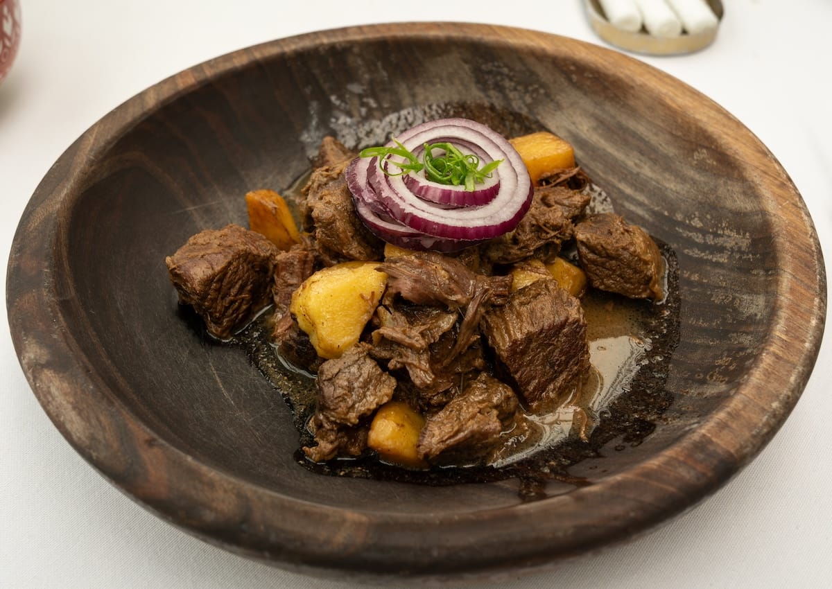 a dish with horse meat, potatoes, onions and more on a table
best restaurants in almaty, kazakhstan