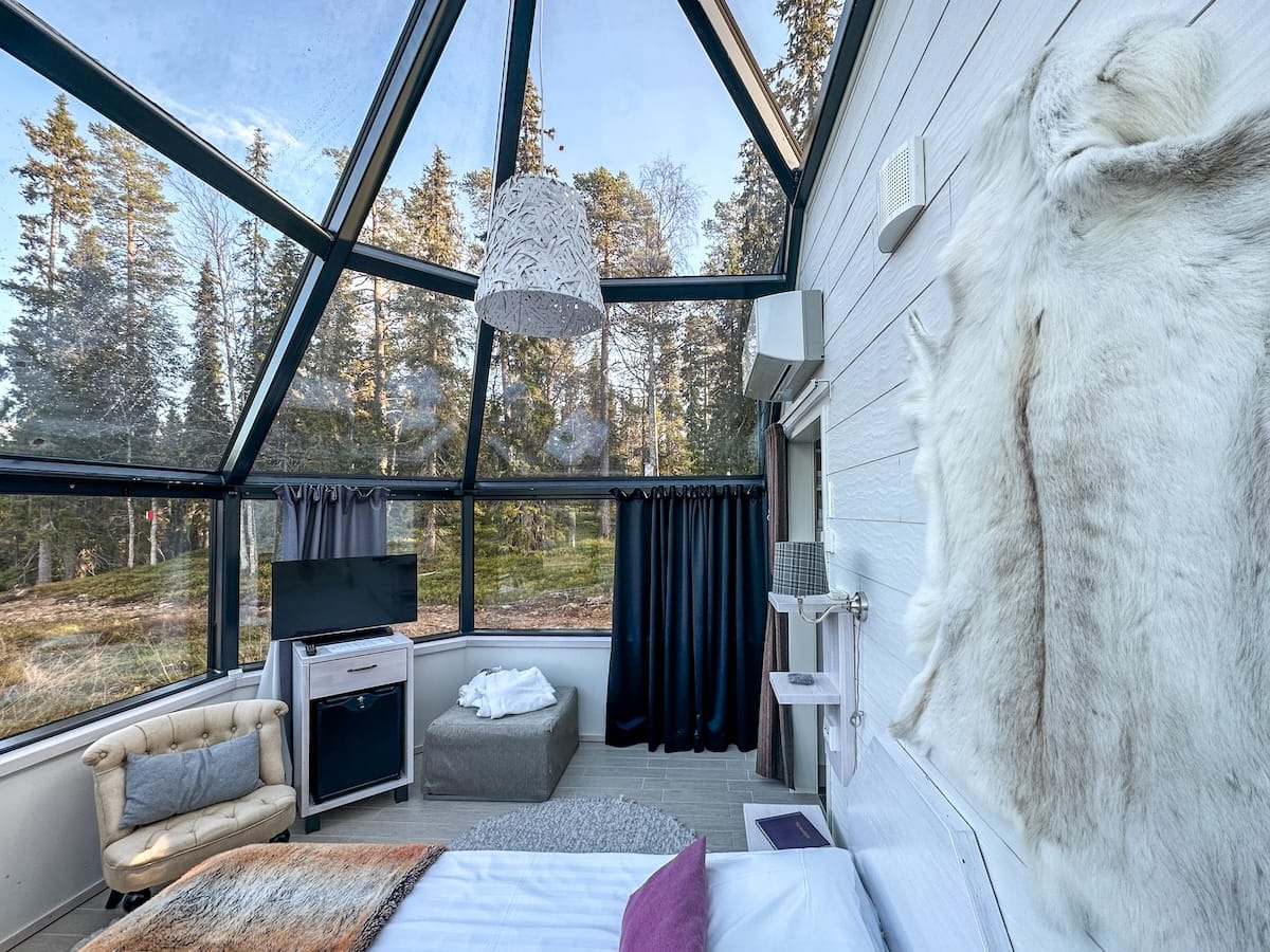 the inside of a glass igloo in autumn in lapland