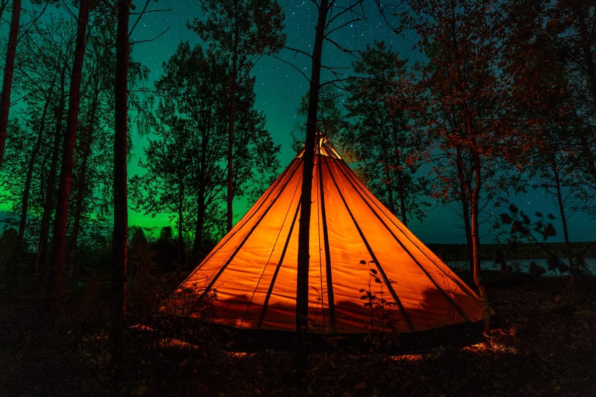 Northern lights in Rovaniemi | A Local's Guide a teepee under the northern lights in lapland
