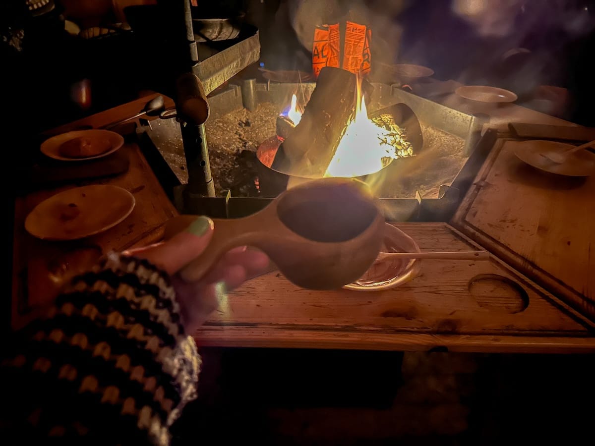 Inside a lavvu post-snowmobiling