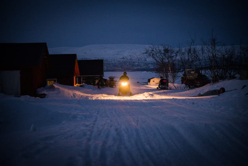 Snowmobiling in the evening in Abisko
