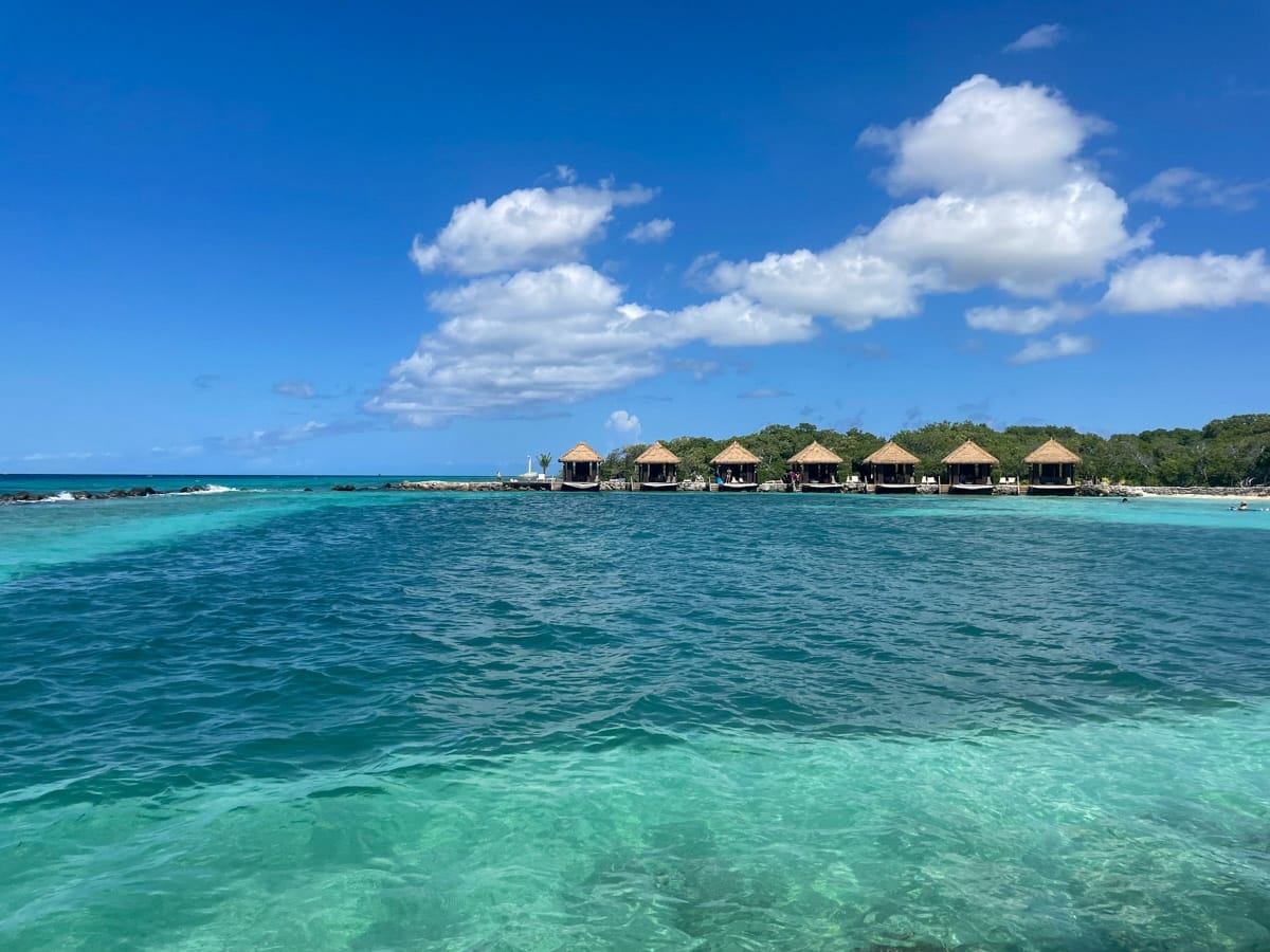 a group of huts on a beach at Iguana Beach in Aruba