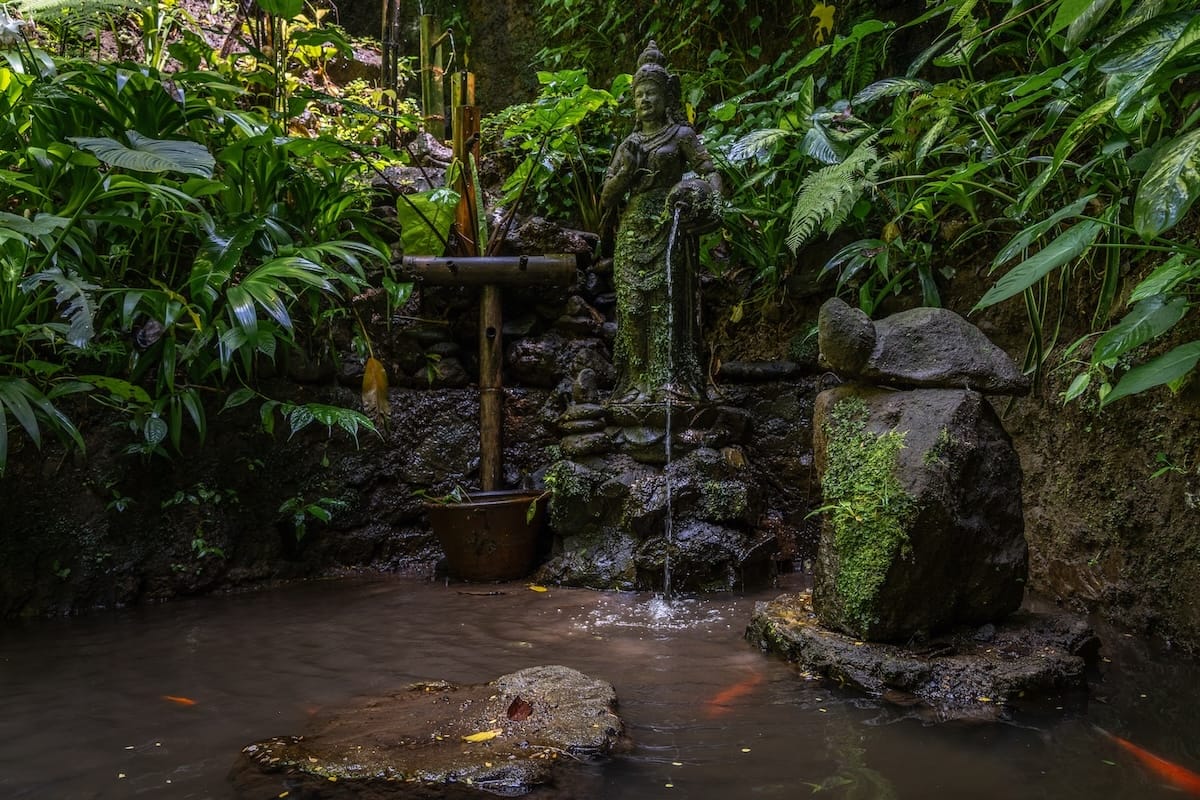 This is a fountain and some landscaped area near a waterfall