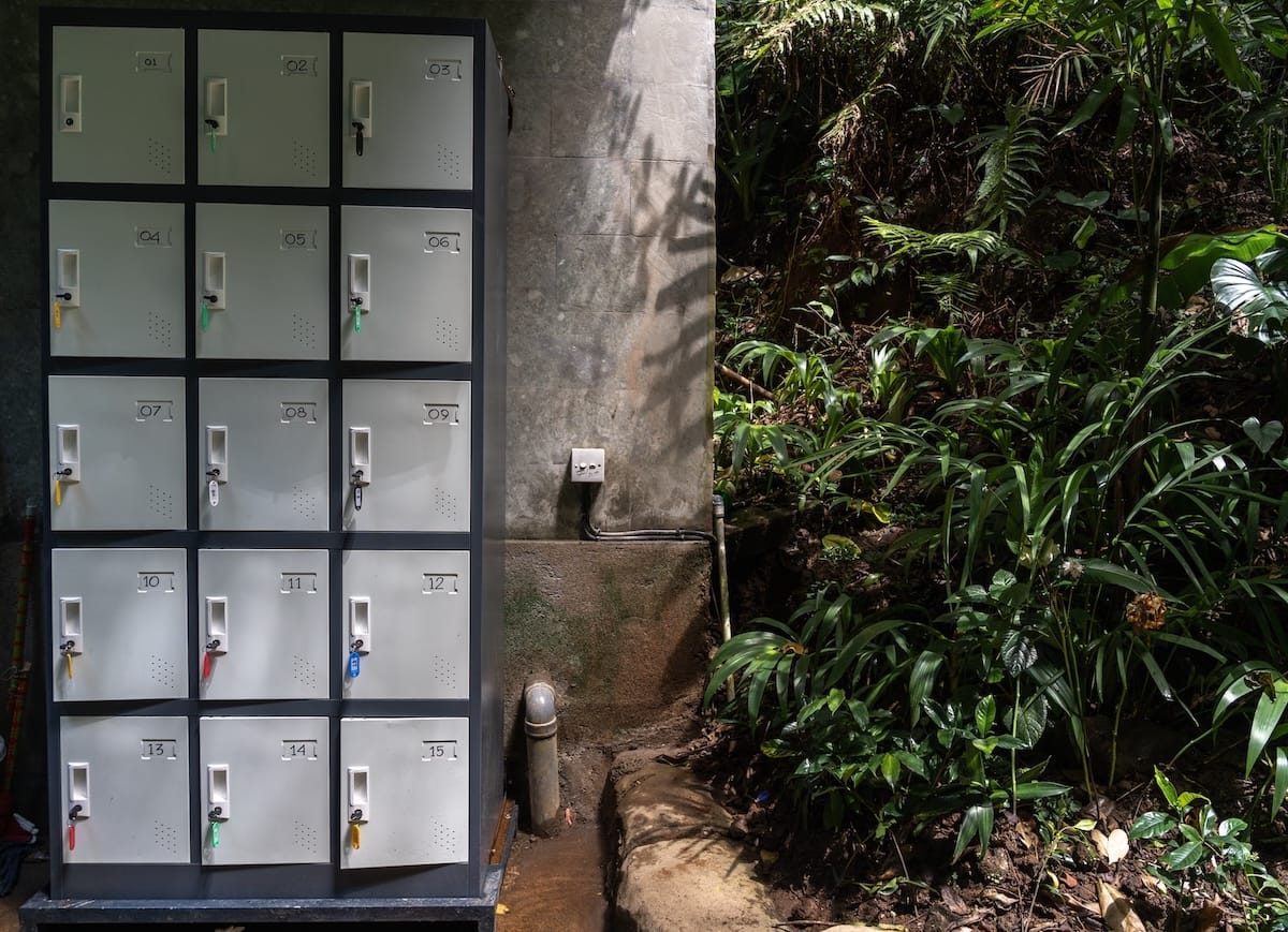 These are grey/white lockers that are cube shaped by a waterfall in Bali - there are many trees around