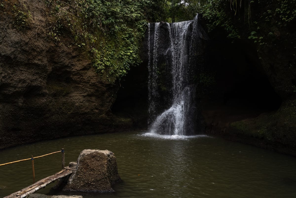 This is a photo of Suwat Waterfall in Bali in the Gianyar regency - it is a not-so-powerful waterfall with a pool below it