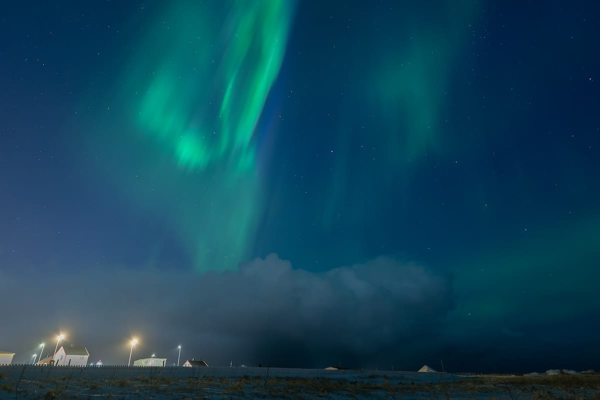 These are northern lights over Vardø - nothing much in the photo except a bright teal/green aurora.