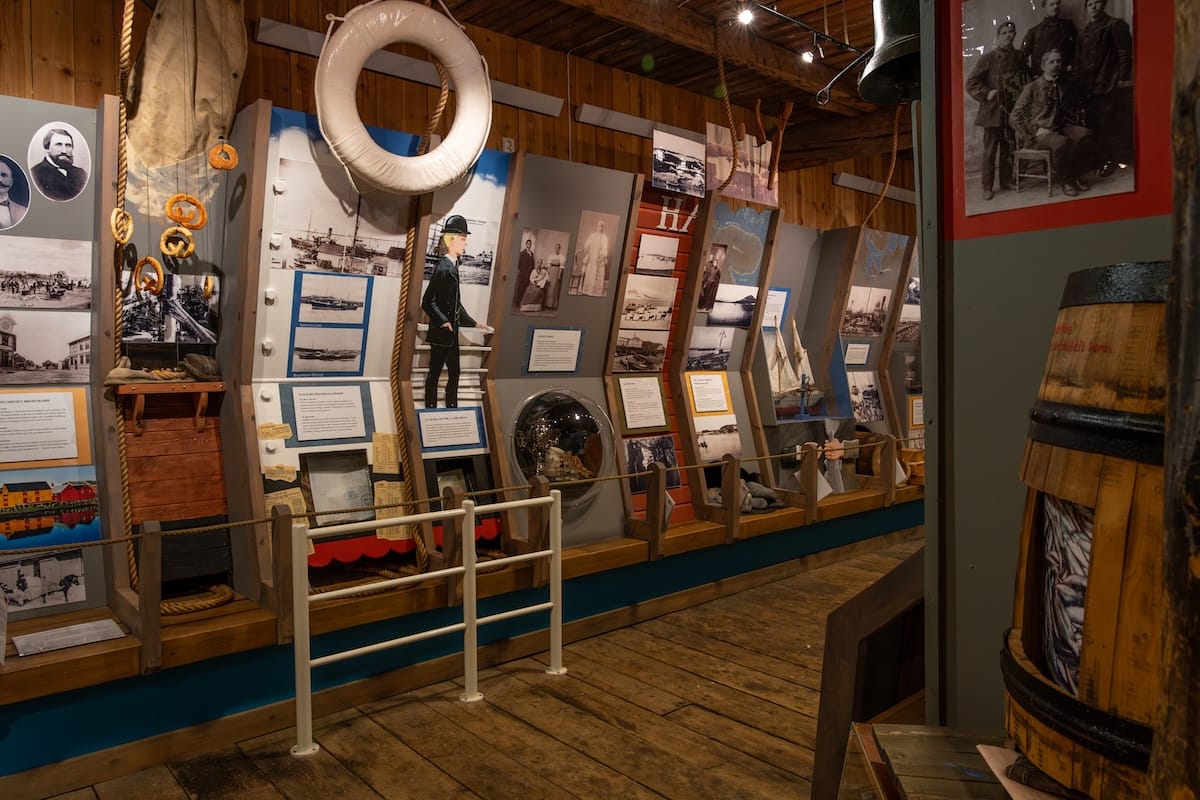 Inside a museum with a lot of exhibits and an old wooden floor. Pomor Museum in Vardø, Norway