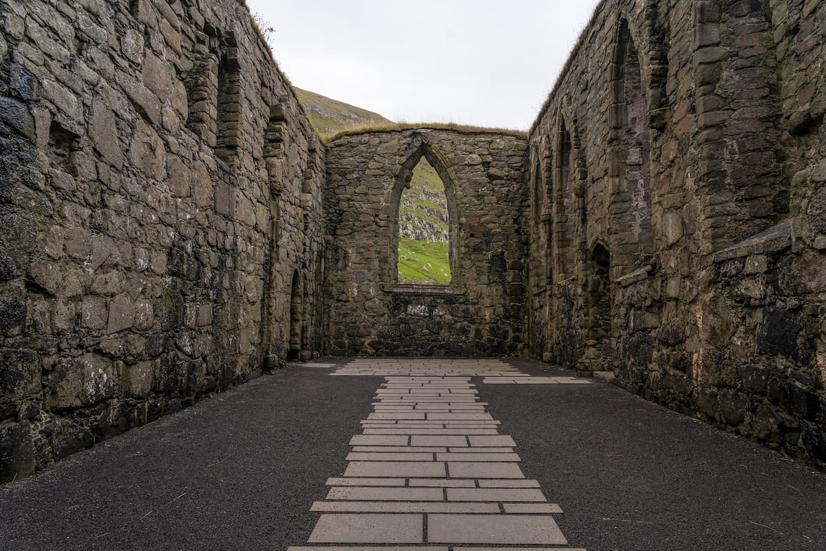 Inside St. Magnus Cathedral in Kirkjubøur

the ruins of a stone church with no roof in the faroe islands