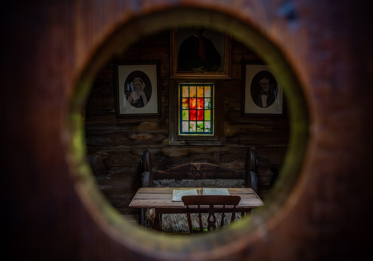 looking inside a locked room in the faroe islands with a desk and stained glass window