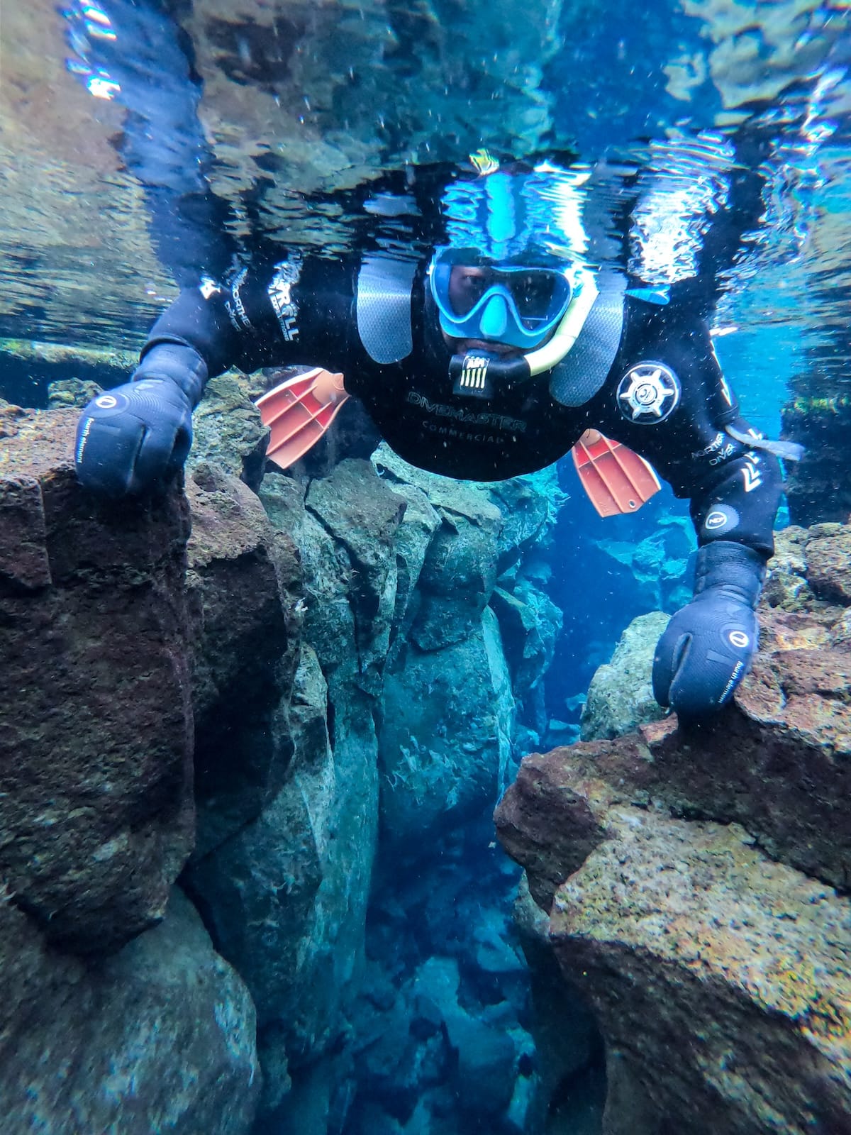It is quite cold when snorkeling in Silfra.

This is a photo of a person snorkeling in clear blue waters with a dry suit and a facemask.