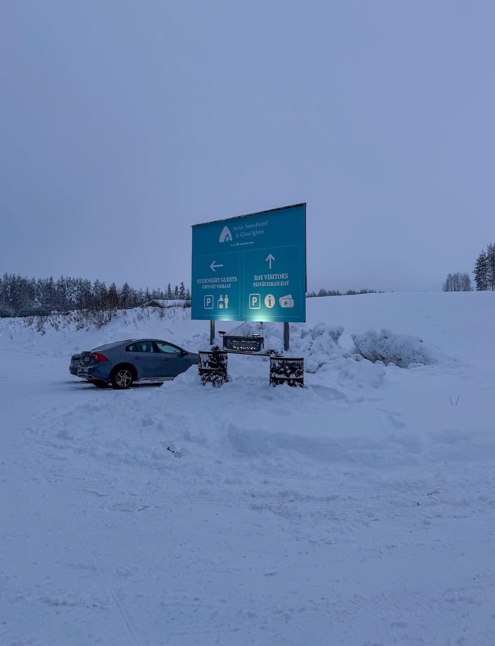 Visiting the Arctic SnowHotel in Rovaniemi
______

A sign in the snow indicating which parking lot to go to for day-trippers