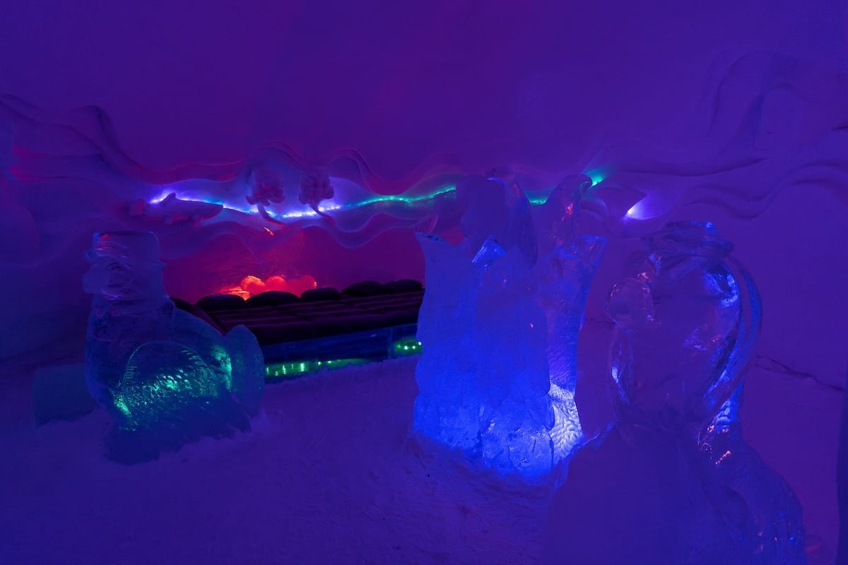 Visiting the Arctic SnowHotel in Rovaniemi
______

A neon room in the ice hotel with a bed and some ice pillars