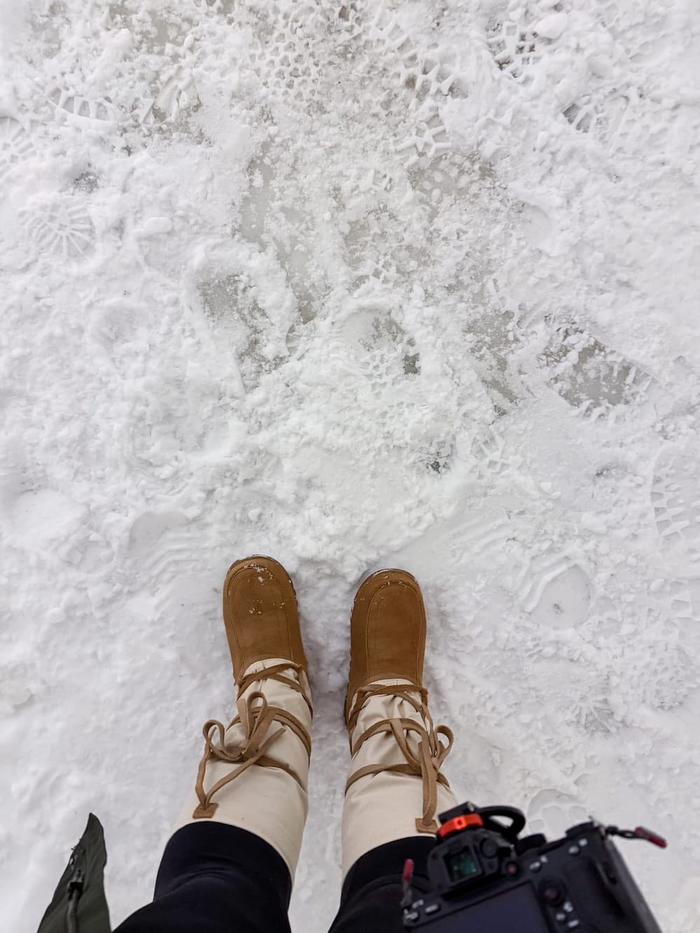 Visiting the Arctic SnowHotel in Rovaniemi
______

A woman standing with mukluks at an ice hotel with exposed ice on the ground