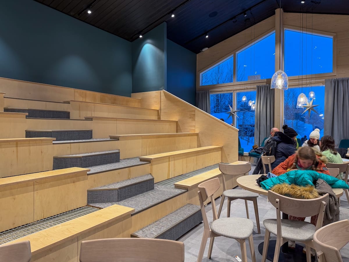 Visiting the Arctic SnowHotel in Rovaniemi
______

 a wooden tiered-seating area inside of a cafe