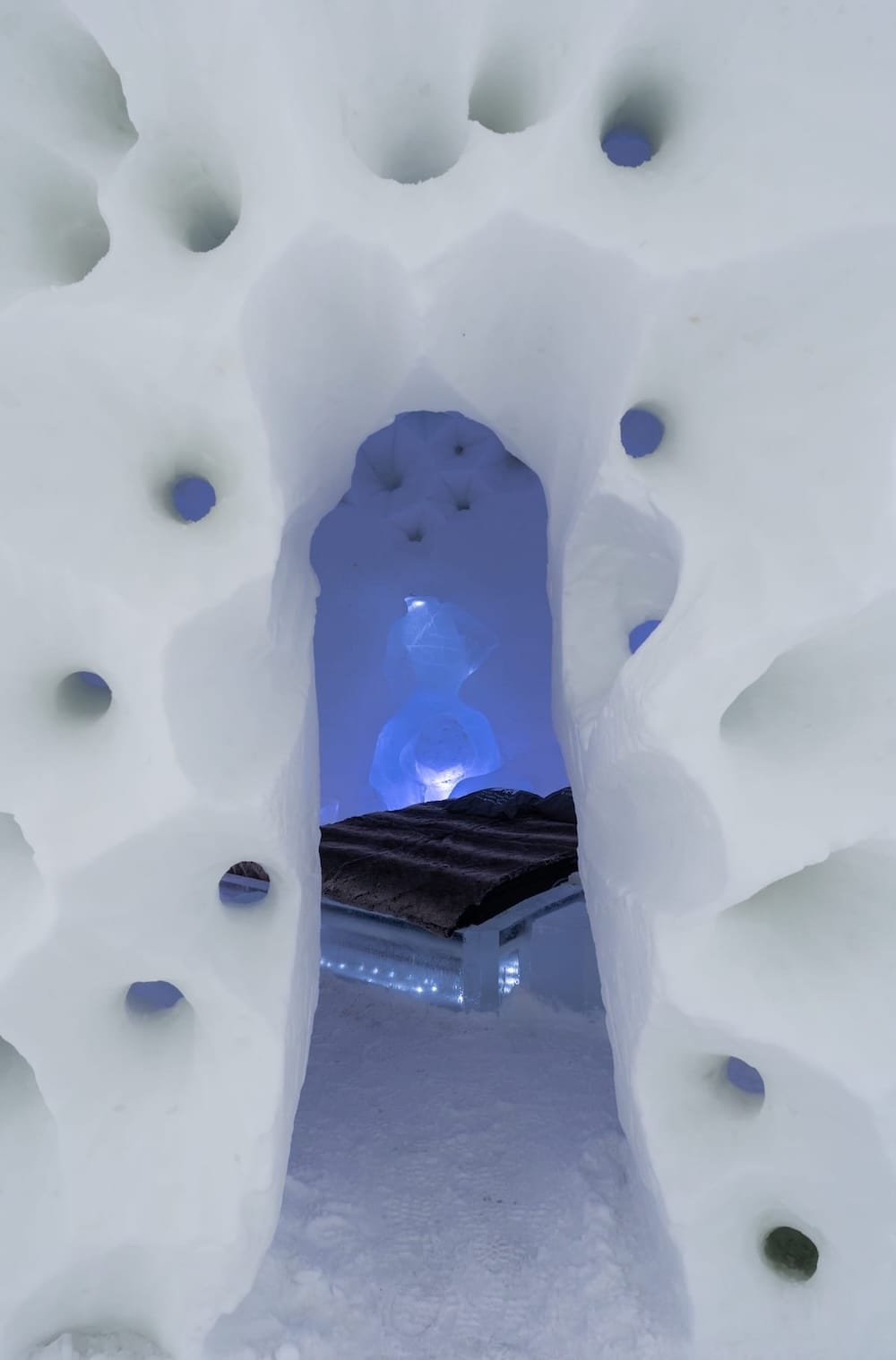 Visiting the Arctic SnowHotel in Rovaniemi
______

The inside of an ice hotel with a small entrance to a bed