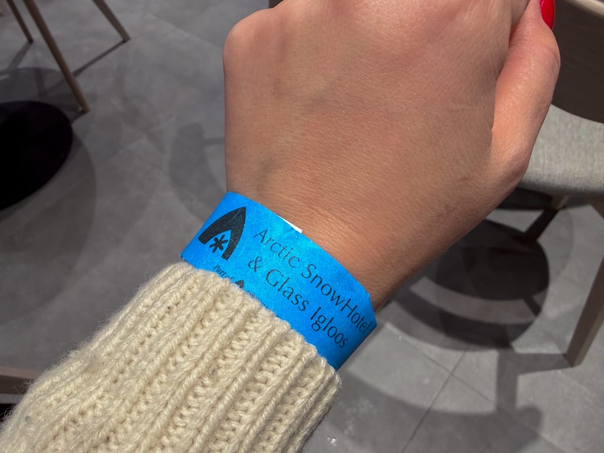 Visiting the Arctic SnowHotel in Rovaniemi
______

a blue wristband on a women's arm