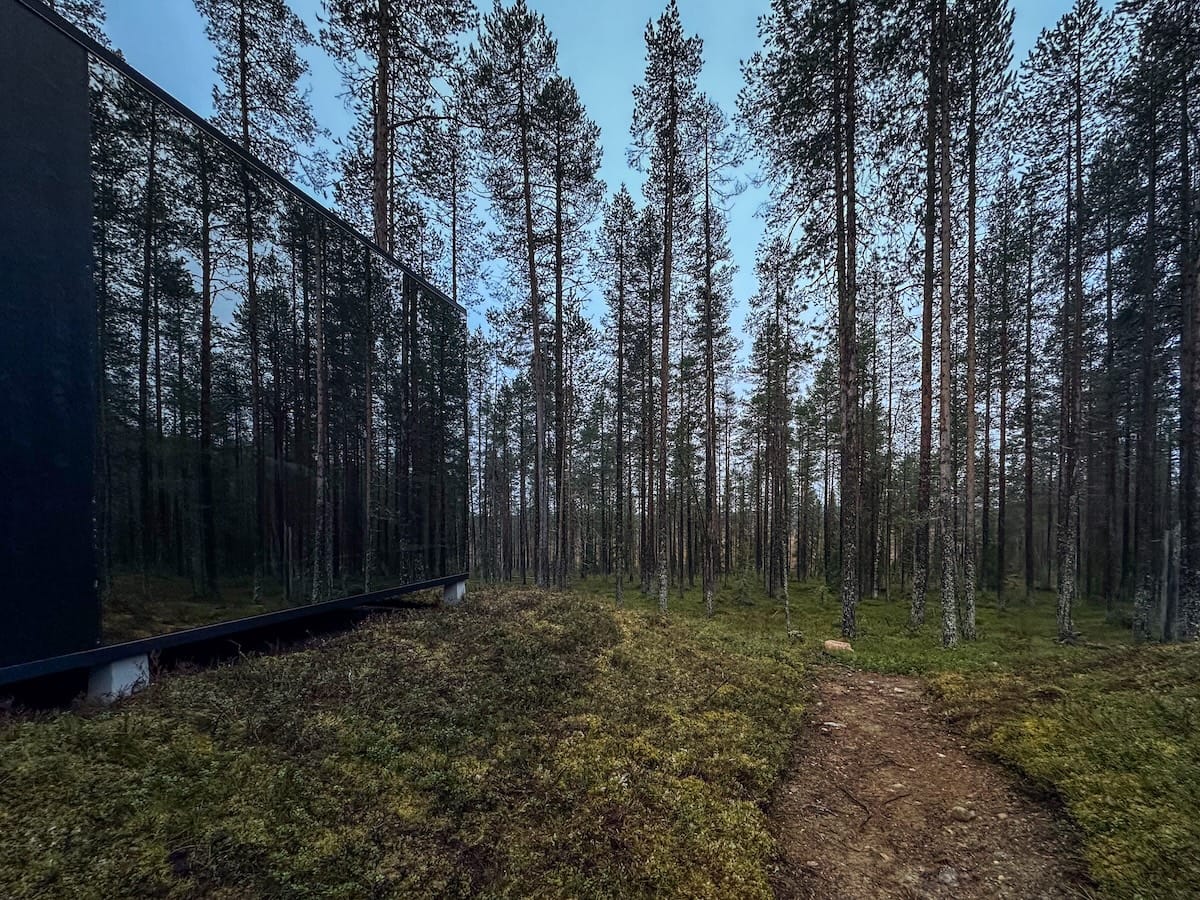 Outside of a reflective cabin in a Finnish forest