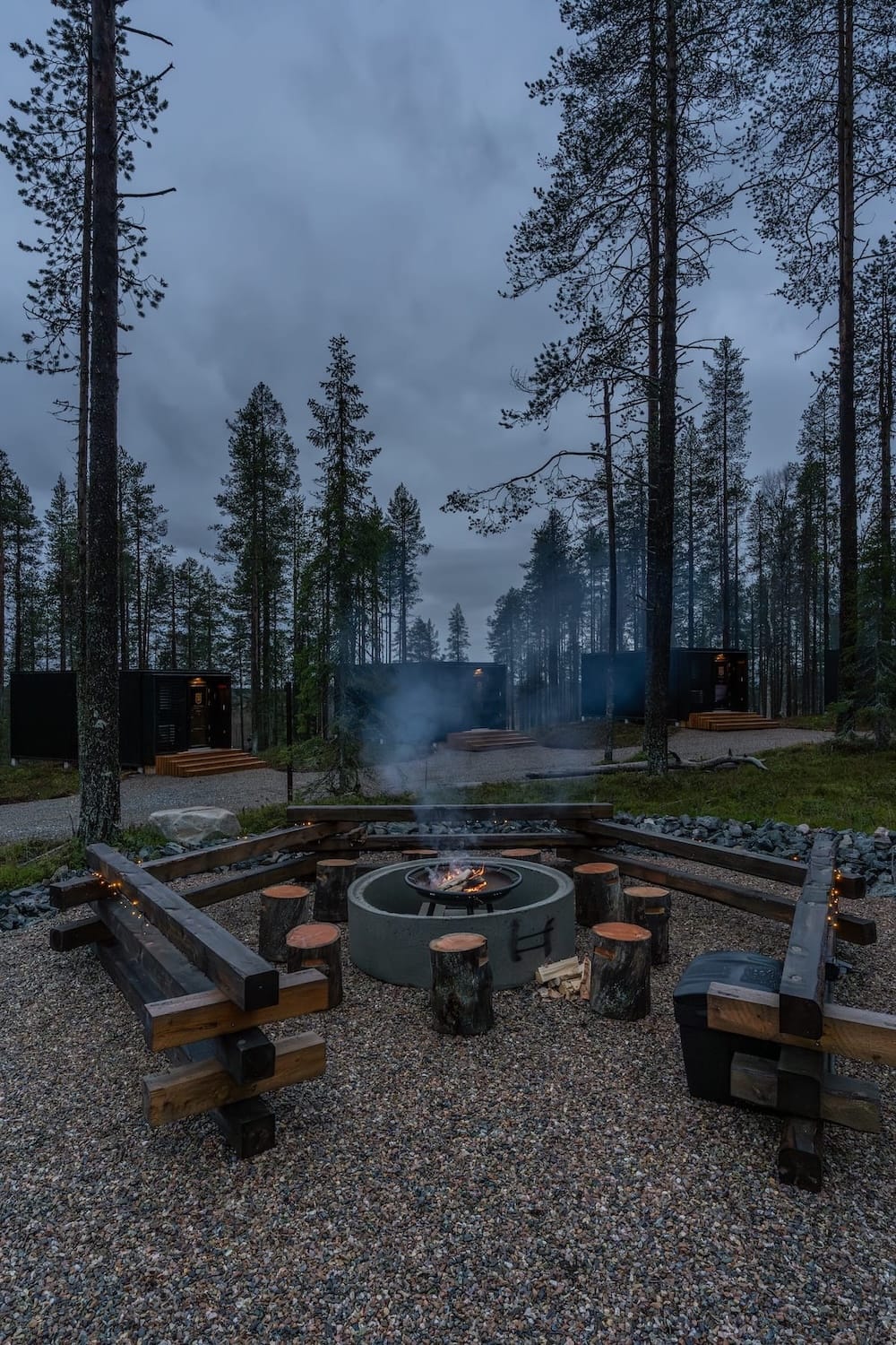 A fire pit and seating around it in a Finnish forest