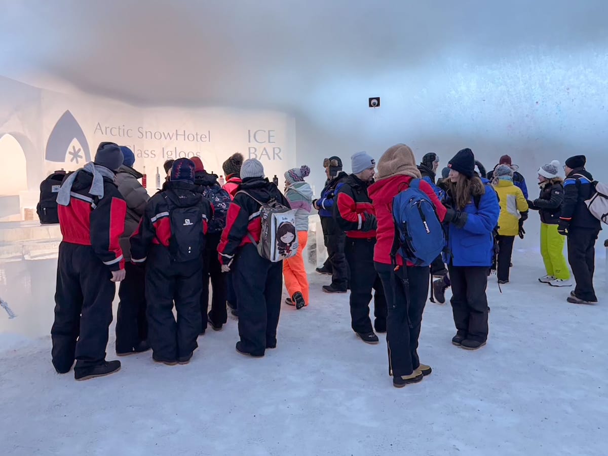 Groups of people standing in an ice bar in Finland