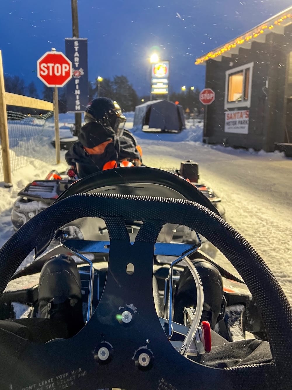 Ice karting in Rovaniemi | Santa's Motor Park
A person inside an ice kart in the snow with a stop sign.