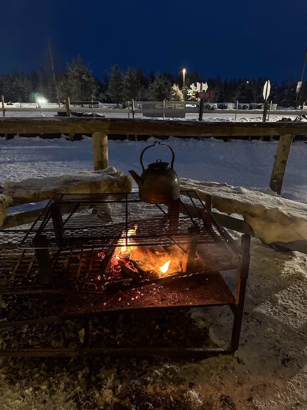 Ice karting in Rovaniemi | Santa's Motor Park
A fire with a pot over it under a dark blue sky.
