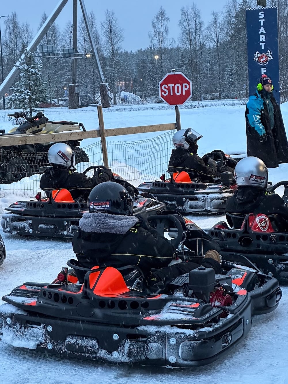 Ice karting in Rovaniemi | Santa's Motor Park
A line of people in ice karts with a stop sign in the background.