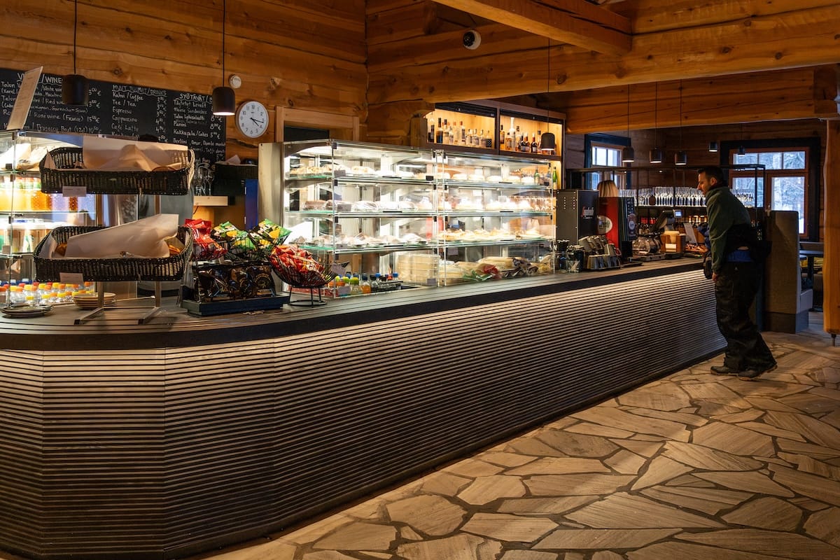 How to visit Lapland Hotels SnowVillage from Levi and Ylläs
Photo: A bar area of a cafe with a lot of pastries for sale.