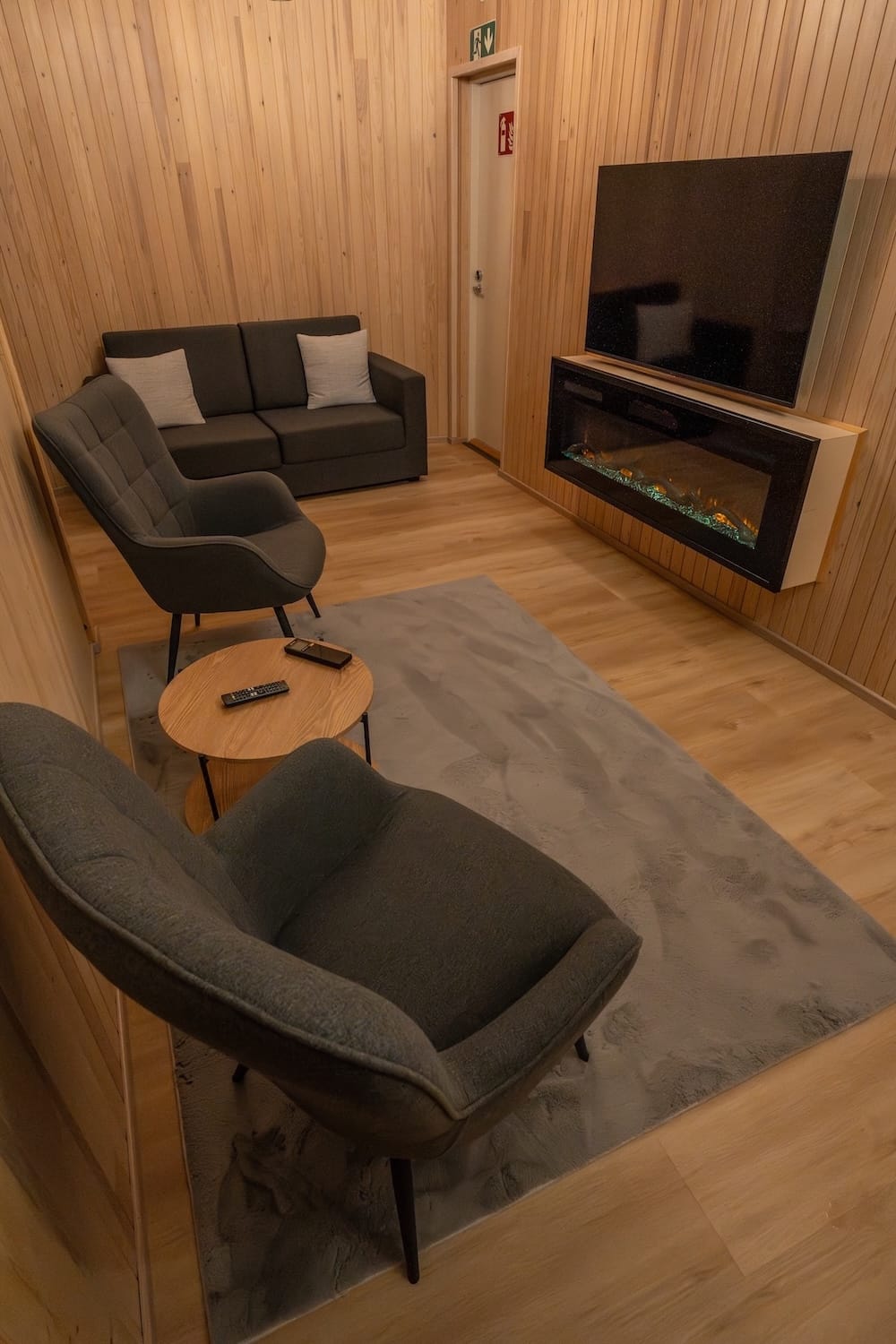 Livo Arctic Resort
_____
A carpet with two chairs, a table, a sofabed, aesthetic fireplace, and tv