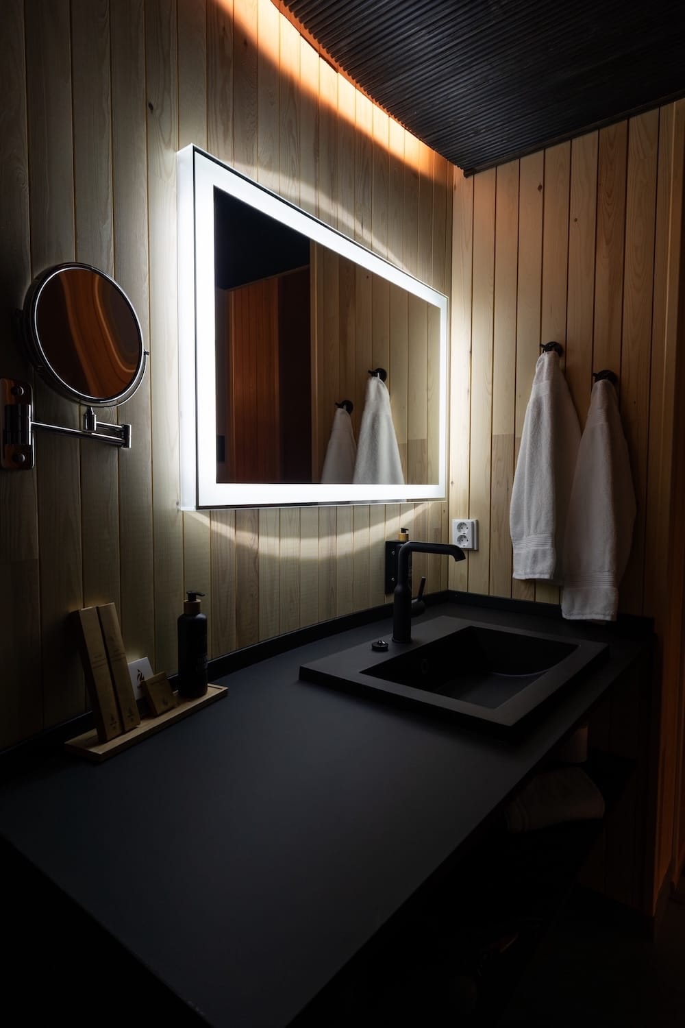 Livo Arctic Resort
_____
a bathroom sink, mirror, towels hanging, and some toiletries
