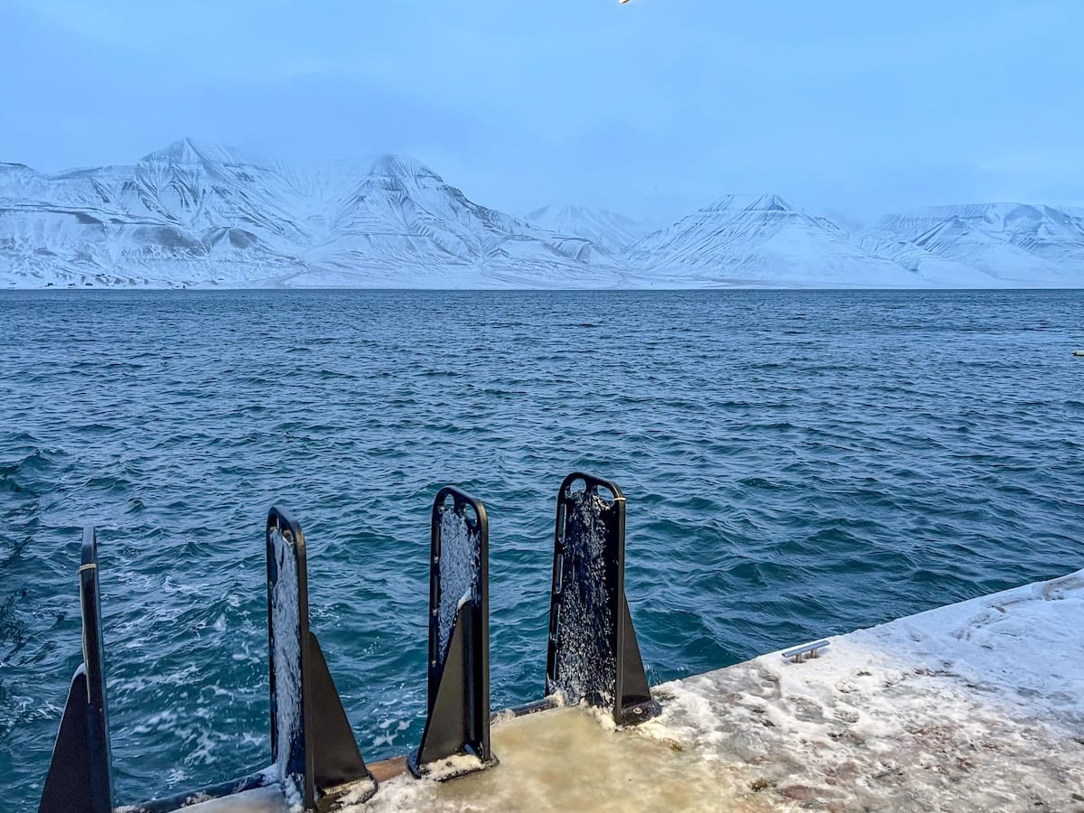 Visiting Svalbad Sauna in Svalbard
____
icy ground with ladders going into the sea
