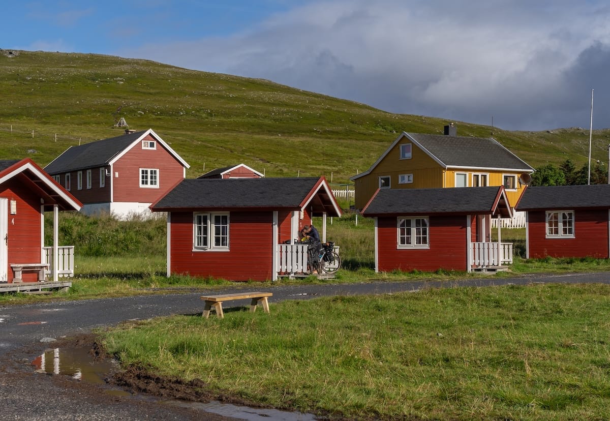 Where to Stay at the North Cape in Norway (+ Honningsvåg)
a bunch of red cabins in a treeless, green landscape
