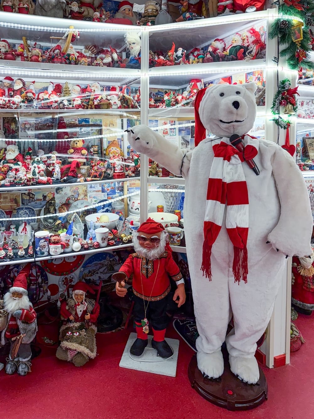 inside a cluttered museum filled with christmas items (and a large polar bear)