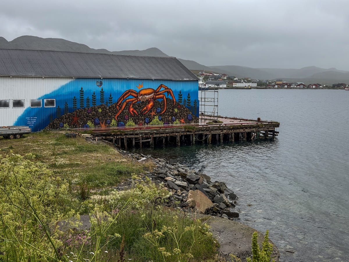 street art on a wooden harbor building of a crab