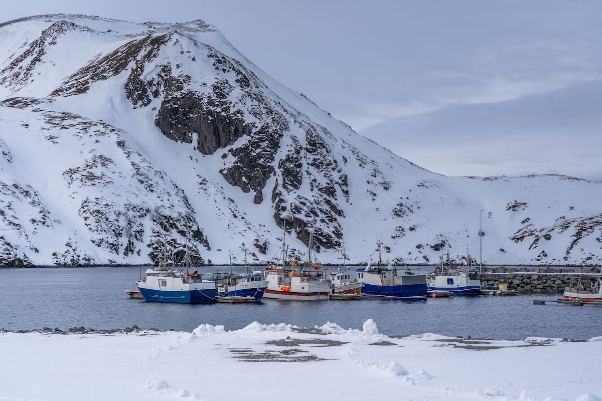 Where to Stay at the North Cape in Norway (+ Honningsvåg)
a small fishing harbor with boats in the seas and snow on the ground