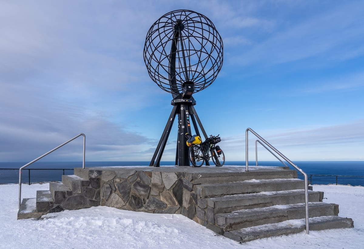 Where to Stay at the North Cape in Norway (+ Honningsvåg)
a bike in front of the North Cape globe with a snowy ground