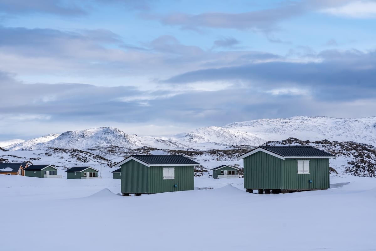Where to stay near North Cape and Honningsvåg travel guide
Green cabins in the snow on a treeless landscape